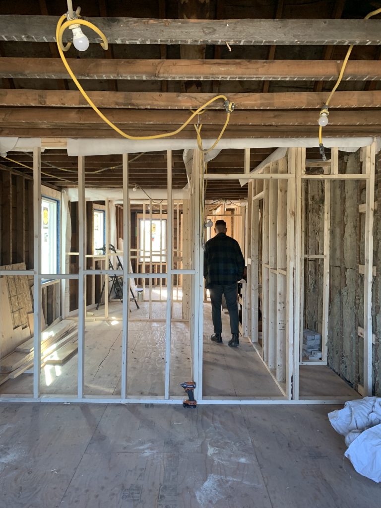 A room that is under renovation, with exposed new wood framing being built.